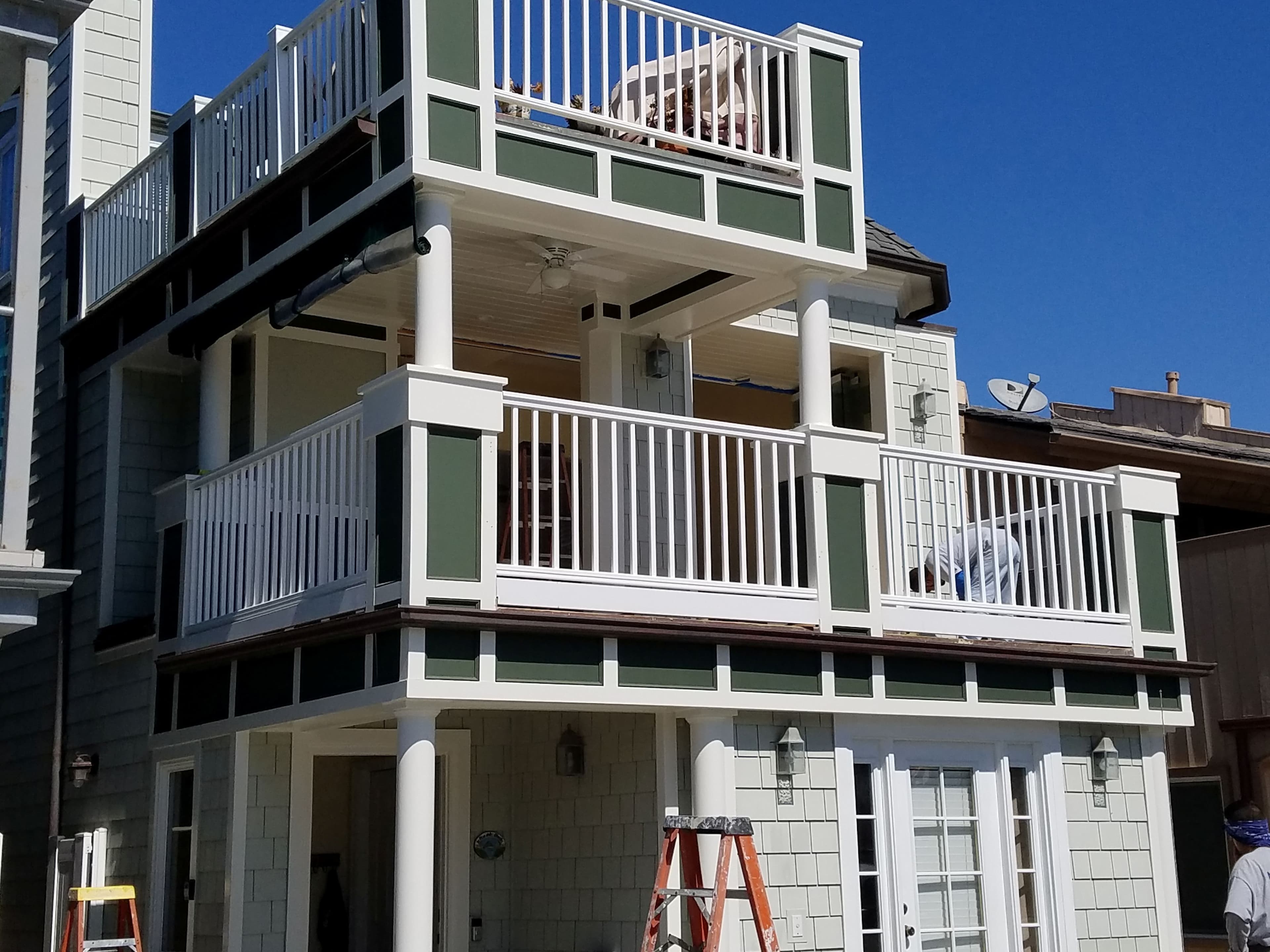 Multi-story deck expansion with white composite railings – Newport Beach, CA