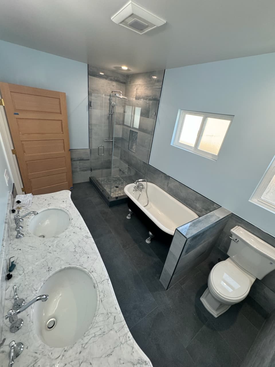 Luxury bathroom with clawfoot tub and marble vanity